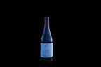 A bottle of Cardenal Rodrigo de Castro red wine on a wooden rail above the Sil canyon