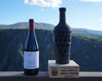 A bottle of Cardenal Rodrigo de Castro red wine beside an award trophy, above the Sil canyon